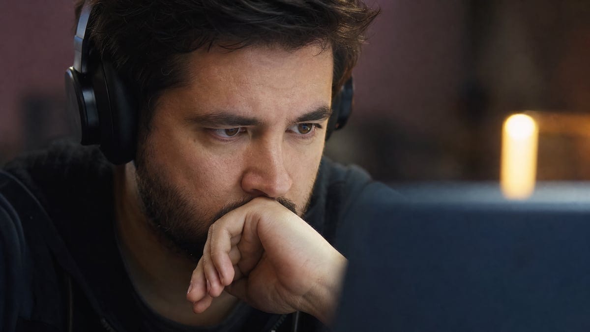 Online poker player focused on computer screen