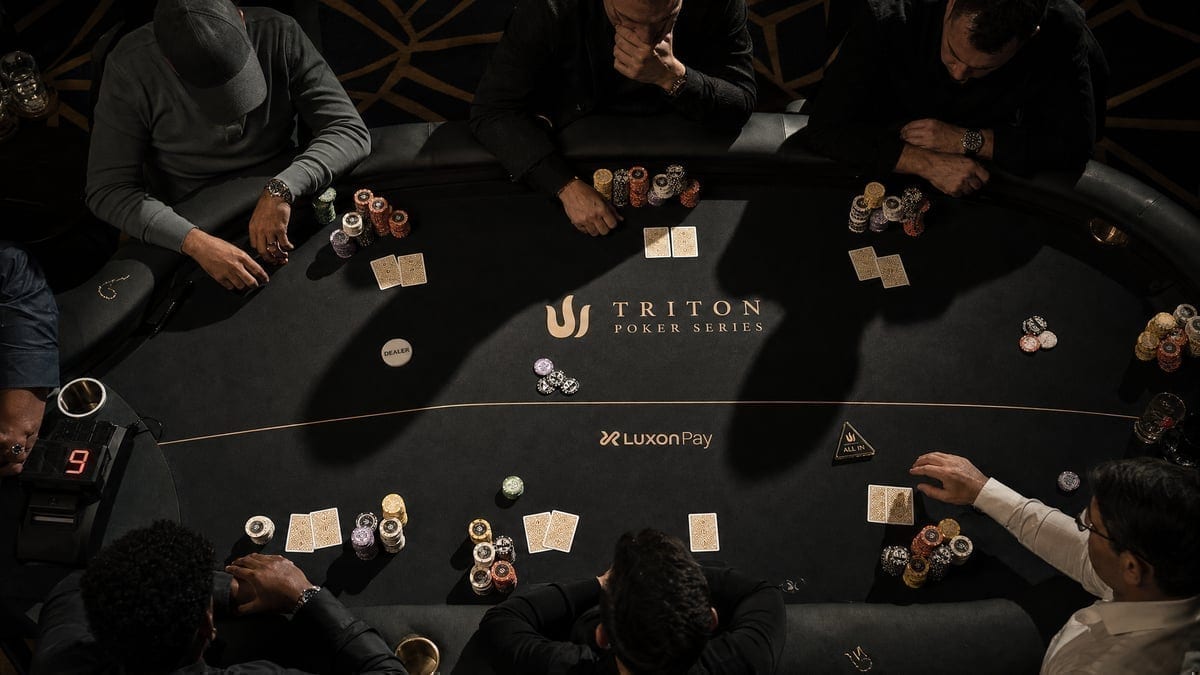 High stakes poker table with massive chip stacks at Hustler Casino
